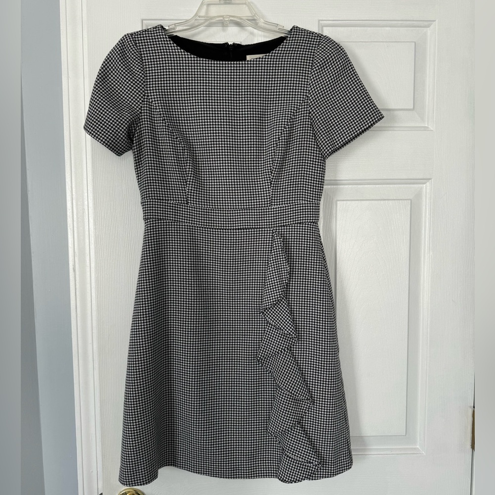 Black and white herringbone pattern mini dress with ruffle detail!
